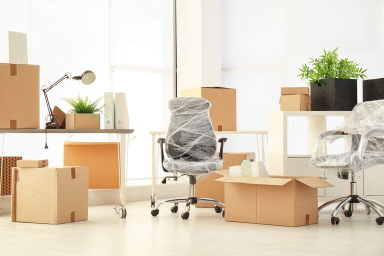 A family packs labeled boxes in a sunlit living room, preparing for a household move.